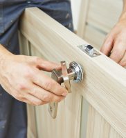 carpenter at door lock installation