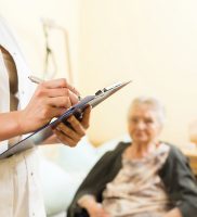 Young nurse and female senior in nursing home